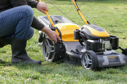 Adjusting Lawn Mower Cutting Height &ndash; Close Up of Grass Cutting Preparation and Maintenance