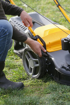 Adjusting Lawn Mower Cutting Height &ndash; Close Up of Grass Cutting Preparation and Maintenance