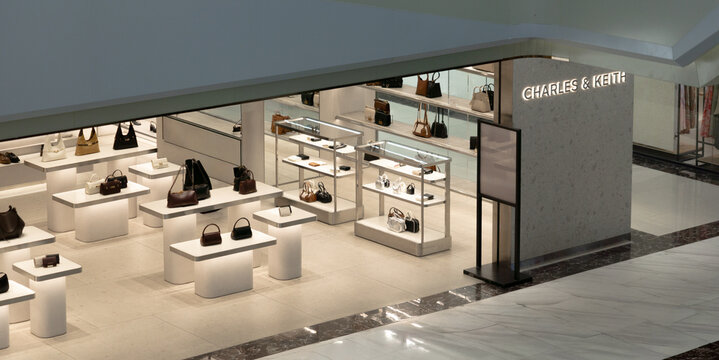 Ho Chi Minh, Vietnam - December 4, 2025: A Charles & Keith store displays handbags on sleek white stands in a modern shopping mall.