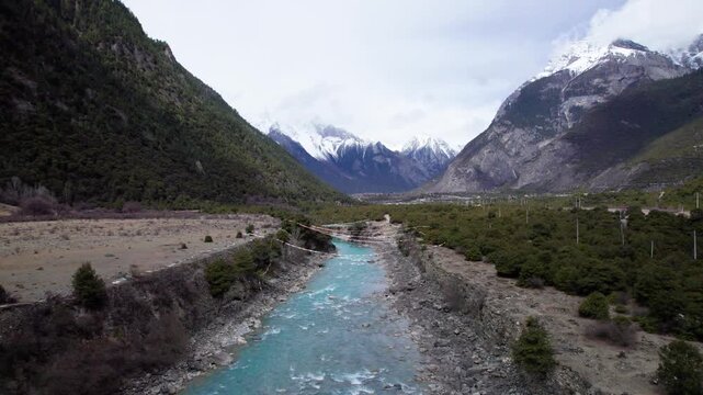 Drone view Parlung Zangbo river running along G318 or China National Highway 318 between Bomi and Baxoi County, Tibet, China, beautiful turquoise water in valley, 4k real time footage travel concept.
