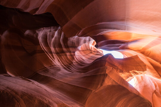 Sunlight Illuminating the Winding Sandstone Walls of a Slot Canyon