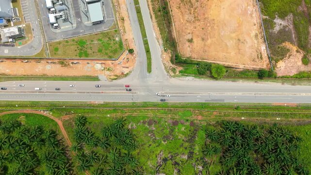 Aerial Top-Down View of Road Dividing Data Center Tech Park from Palm Oil Plantation, Malaysia