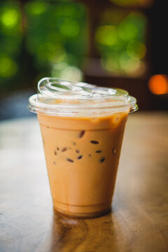 Savoring iced coffee delight cozy  terrace beverage photography relaxed ambiance