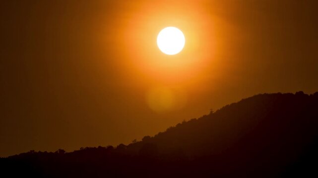 Mountain sunset time-lapse with flowing mist and golden hour light hitting the ridges.