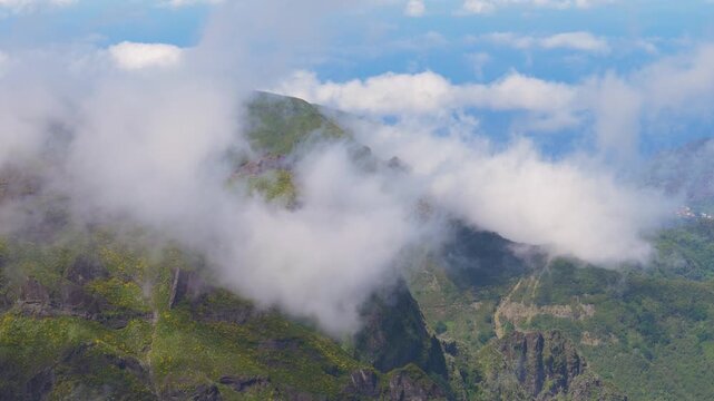 4K video; clouds slowly moving over steep mountains  with flowering broom (Cytisus scoparius) , Madeira Portugal