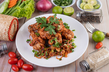 Spicy minced chicken on a white plate complete with cucumber, lettuce and side dishes. © SR  Designer