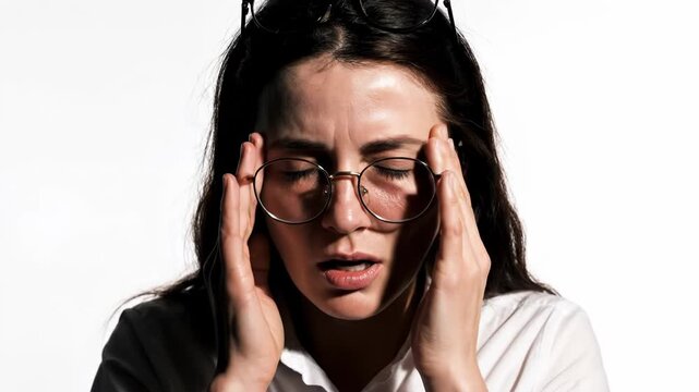Stressed young woman covering her face with hands isolated on white background