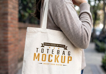 Woman Holding a Tote Bag in The Street Mockup 