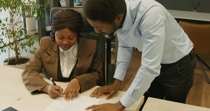 Legal professional monitors client signing of important official papers