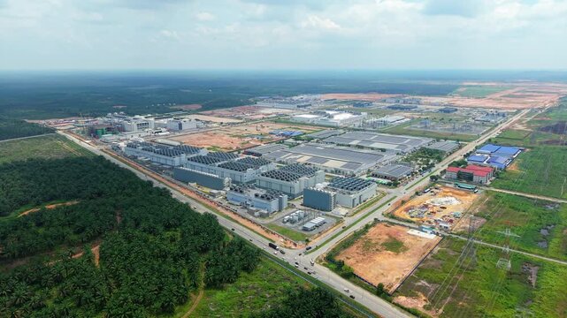 Aerial Pull-Out of Digital Infrastructure Campus Emerging from Tropical Palm Oil Plantation, Malaysia
