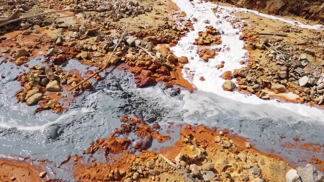 Acidic mine residual water drainage, flowing into decanting pond. Rosia Montana, Romania