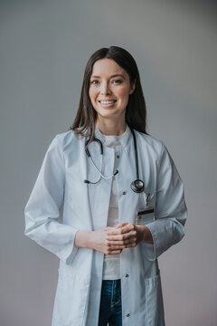 Scientist in lab coat with stethoscope smiling indoors at workplace