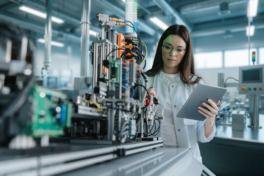Scientist adjusting laboratory sorting machine and recording measurements