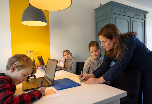 Mother helping children with homework in the Netherlands