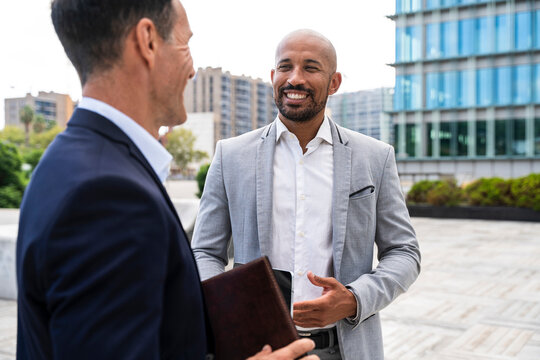 Coworkers talking outdoors during a meeting in financial district