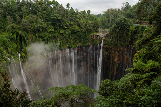 Majestic Tumpak Sewu Waterfall in the lush jungle of Java Indonesia