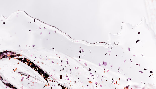 Abstract clear liquid with glitter on white background