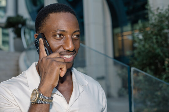 Smiling professional talking on a smartphone in an urban setting