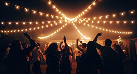 Silhouetted Crowd Dancing Under Festive String Lights at Night