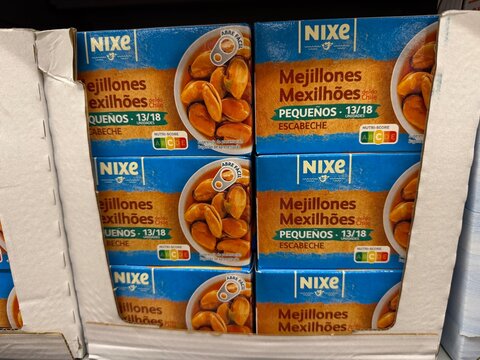 Palmanova, Spain, April 28, 2026, Nixe canned mussels in escabeche sauce, small mejillones from chile with nutri score labels displayed in a supermarket cardboard shelf for groceries buying