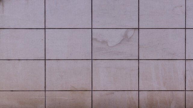 Modern grey stone facade wall texture with square grid pattern