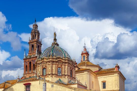 San Pedro Church with bell tower and dome in Carmona, Spain. Traditional baroque architecture, soft cloudy sky, no people