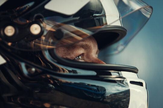 Racing Driver in Carbon Fiber Helmet Sitting Inside Race Car before the start