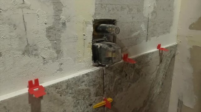 Women pointing out tile and shower diverter 1