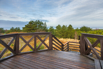 Fototapeta premium Wooden observation deck overlooking Czolpino dunes Baltic Sea, Poland.
