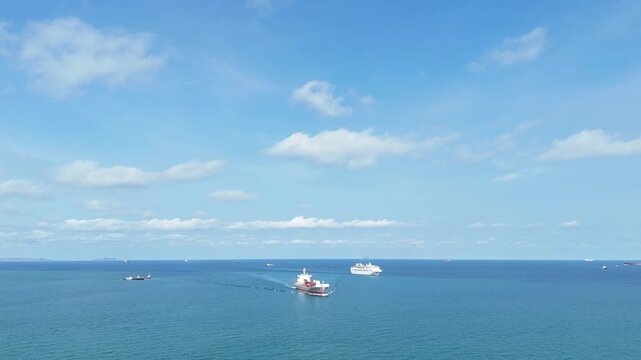 large cargo container ship fully loaded with colorful containers sailing through the deep blue ocean. Global maritime trade, freight transport and logistics business.	
