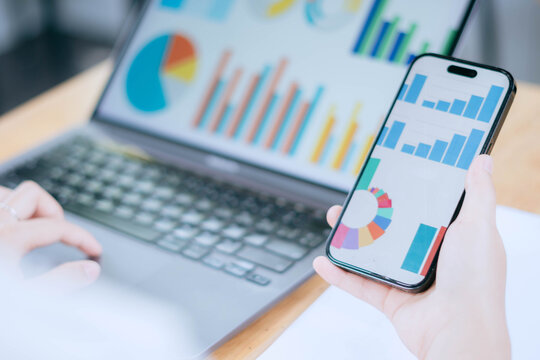 Business Analytics Dashboard on Smartphone and Laptop Screen