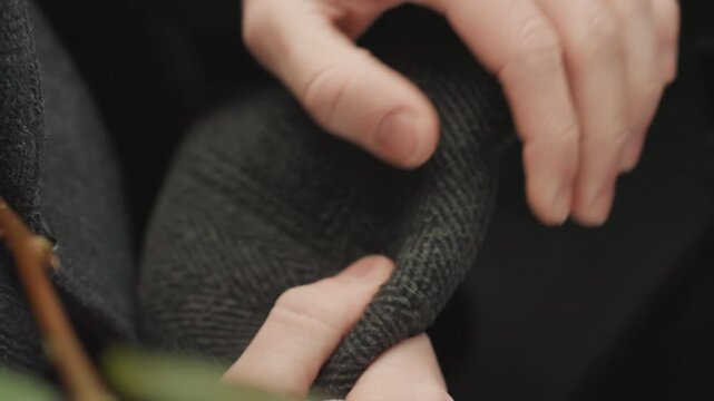 Craftsman shaping soft felt. Close view of artisan creating hat. Focus on handwork adjusting fabric with gentle light. Intimate scene of craftsman molding wool with soft natural illumination