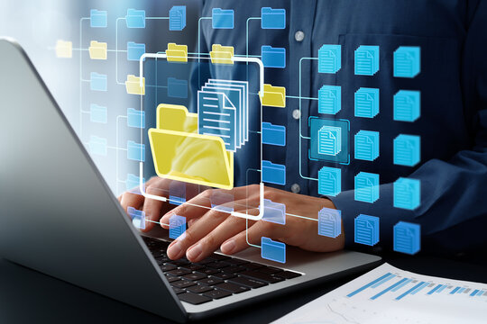 Document management system DMS. File storage and information search software. Document retrieval and database system. Businessman using application for organizing folders on laptop computer.