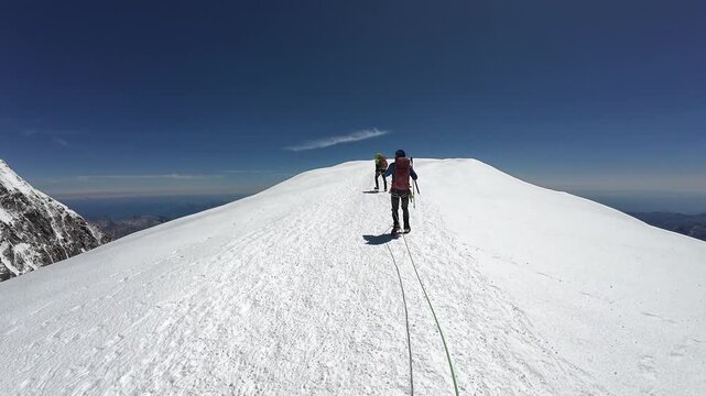 POV mountaineering in rope team with mountaineers towards summit Vincent Pyramid and mountain glacier panorama in summer in Pennine Alps, Italy