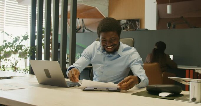 Person expressing delight with raised hands after closing business deal