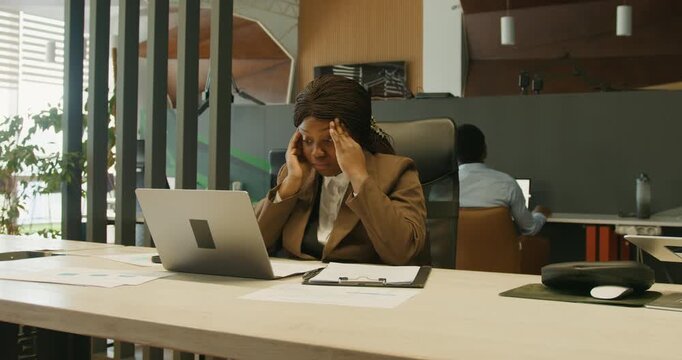 Exhausted woman working. Lady shows fatigue while working in office