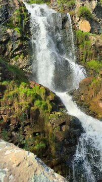 Kamishlinsky waterfall in Altai Republic near Chemal with wooden viewing platform Russia