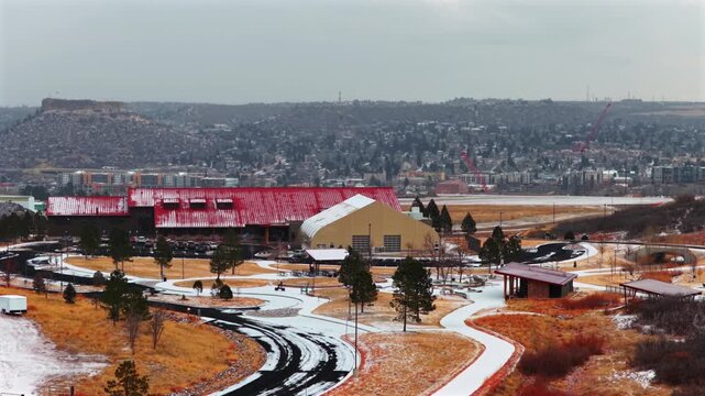 Mac Philip S Miller Park Athletic field Complex Rec Center winter snowy cloudy day Town of Castle Rock downtown Colorado aerial drone Front Range Denver snow covered grounds pan left motion
