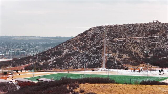 Challenge Hill stair climb Mac Philip S Miller Park Athletic field Complex Rec Center winter cloudy day Castle Rock Colorado aerial drone Front Range Denver snow covered grounds circle left motion