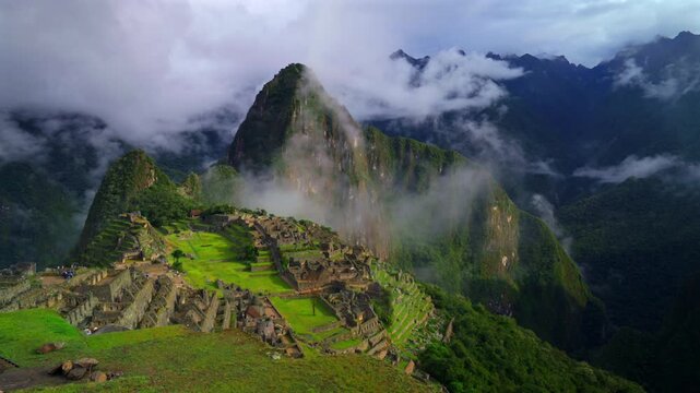 Machu Picchu Peru's Inca Temple low clouds fog layer sunny early morning landscape Huayna Picchu Mountain Inca Trail Circuit Aguas Calientes Peruvian Andres Mountains World heritage site sanctuary