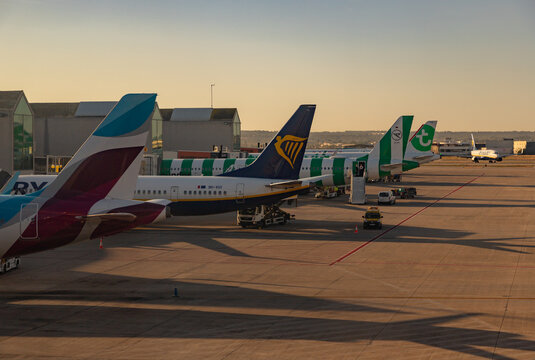 Palma, Mallorca, Spain - August 5, 2025: A picture of multiple planes at the Palma de Mallorca Airport at sunrise.
