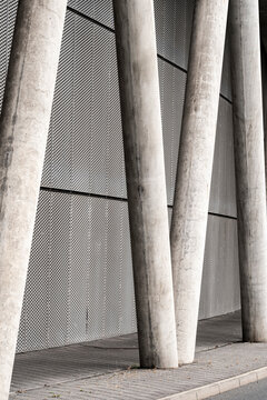 Industrial modern architecture with concrete columns and pillars forming facade structure texture and lines in an urban abstract composition
