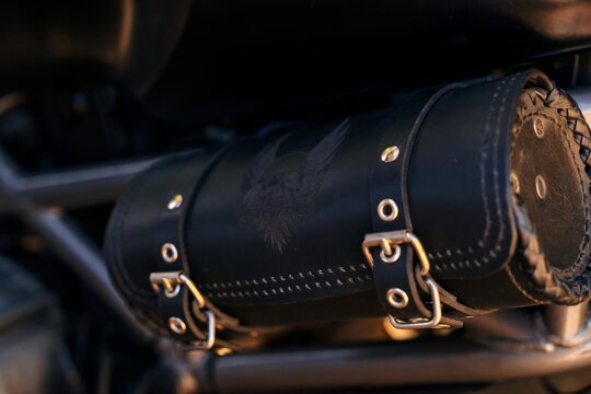 Close-up of leather motorcycle tool bag with metal buckles