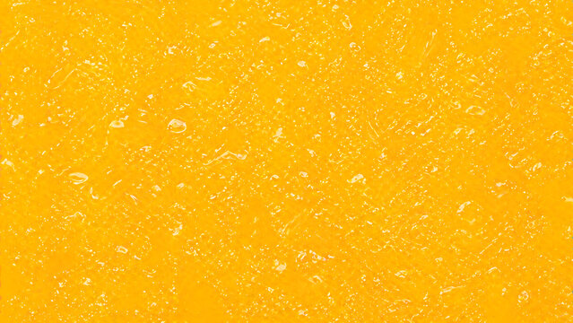 Close-up texture of a bright yellow mango flesh with glistening moisture