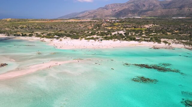 Greece Crete Elafonisi pink sand beach aerial 4K, turquoise shallow water lagoon, Caribbean of Europe exotic island, cinematic drone sea scenery