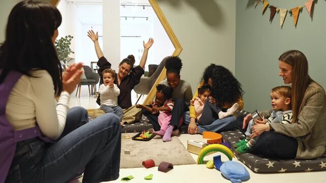 Group of diverse mothers playing with their children in a nursery school