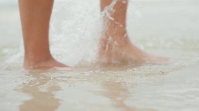 Gentle caucasian woman walking island shoreline, soft shallow water around ankles, quiet reflective steps creating faint ripples, mindful seeker enjoying tranquil seaside moment and inner calm