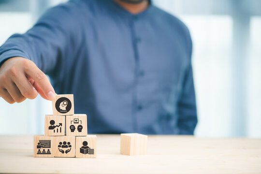 Human resource training and development concept.Business, personal development improving and enhancing competency, performance..Putting wooden cubes training with brainstorm, coaching, learning icons.