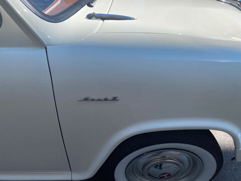 Vintage Hillman Minx Mark II car fender with classic emblem and white wall tire showing automotive heritage