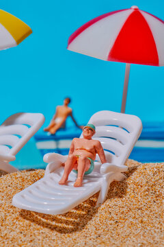 a man sitting on a lounger under an umbrella